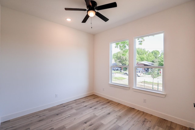 spare room with recessed lighting, baseboards, a ceiling fan, and light wood-type flooring