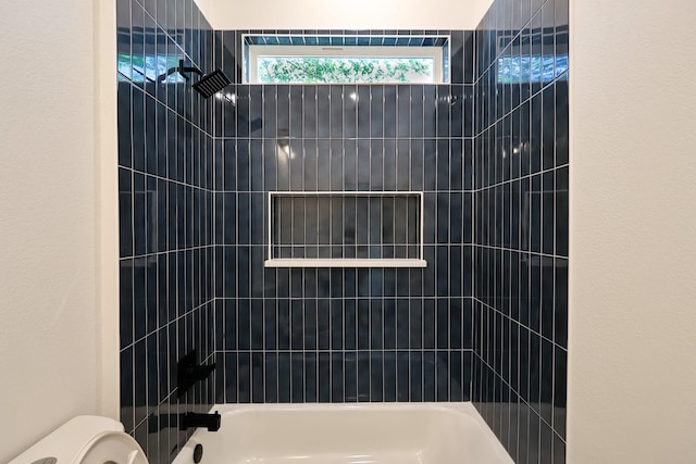 full bathroom featuring tub / shower combination and toilet