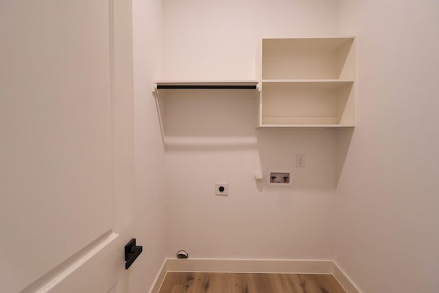 laundry area featuring wood finished floors, hookup for a washing machine, hookup for an electric dryer, baseboards, and laundry area