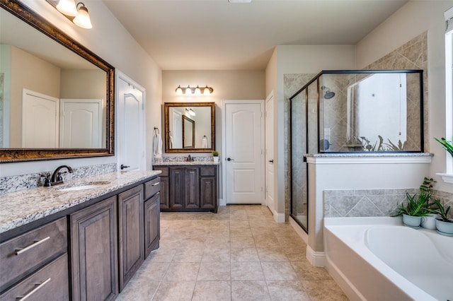 bathroom featuring tile patterned flooring, a sink, two vanities, a garden tub, and a stall shower