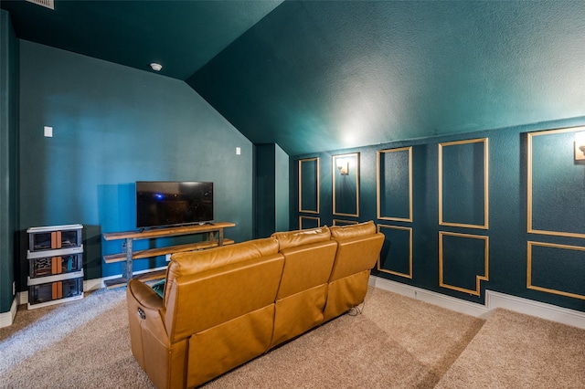 carpeted cinema room featuring lofted ceiling and baseboards