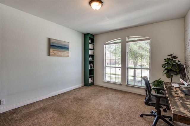 carpeted office space featuring baseboards