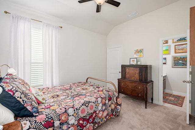 bedroom with carpet floors, visible vents, lofted ceiling, and ceiling fan