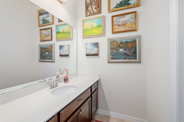bathroom with baseboards, tile patterned floors, and vanity