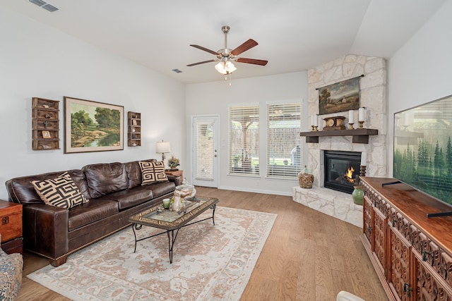 421 Fox Crossing Ln, Prosper, TX 75078 - living area featuring a stone fireplace, a ceiling fan, light wood finished floors, and vaulted ceiling