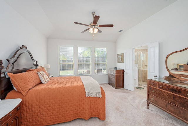 bedroom featuring ensuite bathroom, visible vents, light colored carpet, lofted ceiling, and ceiling fan