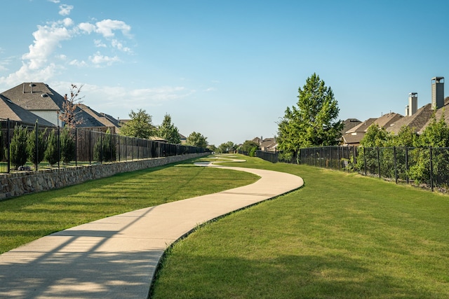 surrounding community featuring a residential view, a lawn, and fence