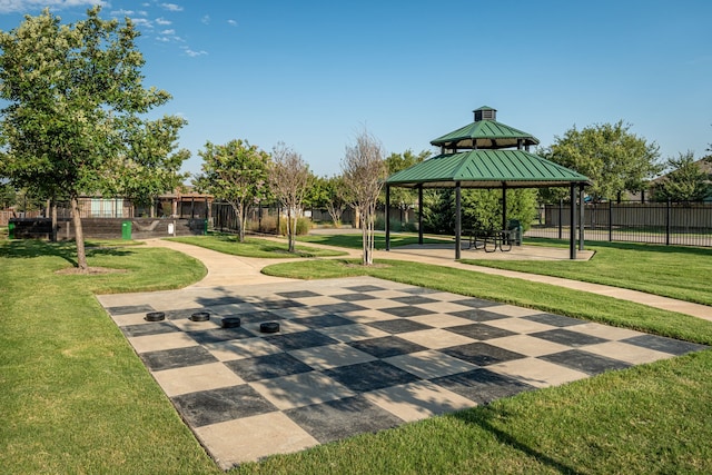 surrounding community featuring a gazebo, a lawn, and fence