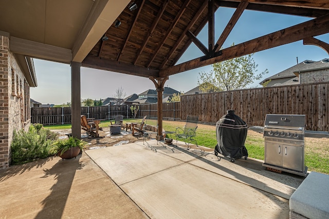 view of patio with a fire pit, a fenced backyard, and area for grilling