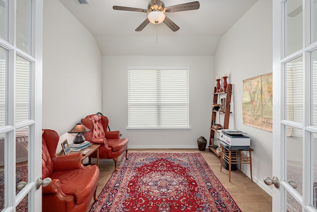 living area with lofted ceiling, wood finished floors, visible vents, a ceiling fan, and french doors