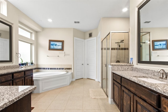 13043 Seattle Slew St, Frisco, TX 75035 - bathroom with a shower stall, tile patterned flooring, two vanities, a bath, and recessed lighting