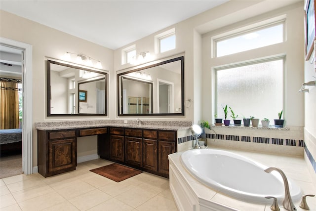13043 Seattle Slew St, Frisco, TX 75035 - bathroom with vanity, a garden tub, and tile patterned floors