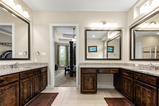 13043 Seattle Slew St, Frisco, TX 75035 - ensuite bathroom with two vanities, a ceiling fan, tile patterned flooring, and baseboards