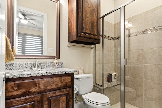13043 Seattle Slew St, Frisco, TX 75035 - bathroom featuring crown molding, toilet, vanity, a shower stall, and ceiling fan