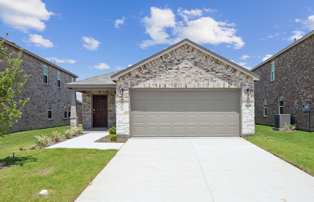 1055 Clear Dusk Ln, Forney, TX 75126 - view of front of house with a front yard, concrete driveway, cooling unit, an attached garage, and stone siding