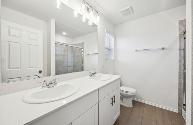 1055 Clear Dusk Ln, Forney, TX 75126 - full bath with a shower stall, toilet, wood finished floors, double vanity, and baseboards