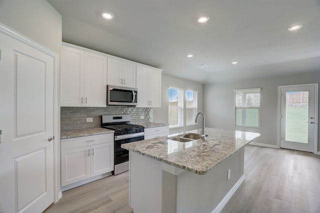 610 Willet Dr, Mckinney, TX 75069 - kitchen with a sink, tasteful backsplash, appliances with stainless steel finishes, a kitchen island with sink, and light wood-style floors