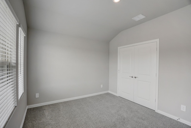 610 Willet Dr, Mckinney, TX 75069 - unfurnished bedroom featuring lofted ceiling, a closet, carpet, baseboards, and visible vents