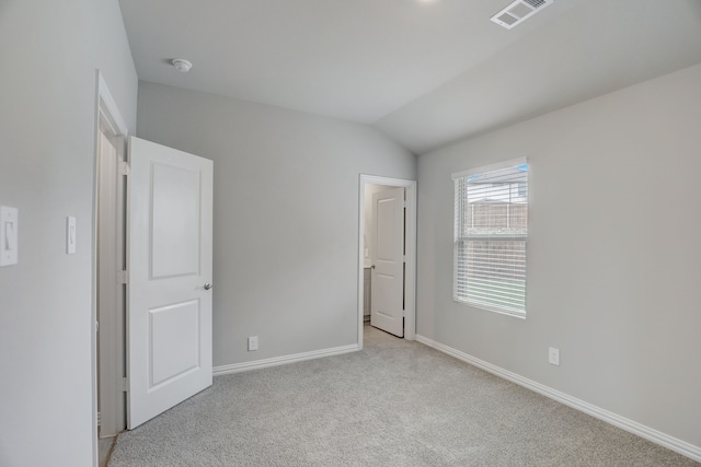 610 Willet Dr, Mckinney, TX 75069 - unfurnished bedroom with light colored carpet, lofted ceiling, baseboards, and visible vents