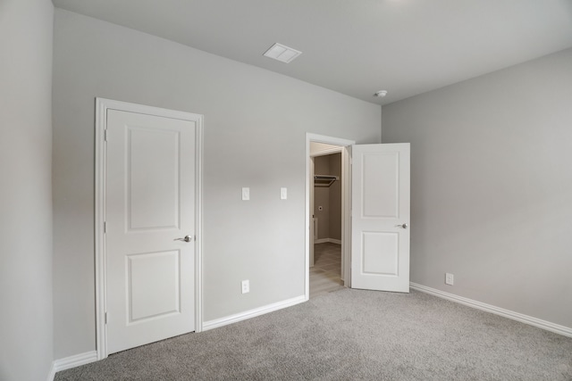 610 Willet Dr, Mckinney, TX 75069 - unfurnished bedroom with baseboards, carpet flooring, visible vents, and a walk in closet