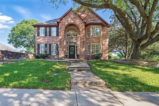 1102 Belvedere Dr, Allen, TX 75013 - traditional home with a front lawn, brick siding, and fence