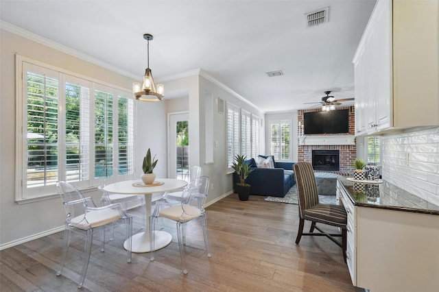 1102 Belvedere Dr, Allen, TX 75013 - dining area featuring light wood-style floors, visible vents, baseboards, and ceiling fan with notable chandelier