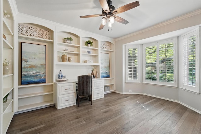 1102 Belvedere Dr, Allen, TX 75013 - office with crown molding, built in desk, ceiling fan, baseboards, and dark wood-style flooring