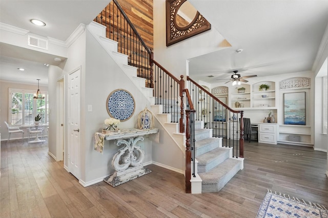 1102 Belvedere Dr, Allen, TX 75013 - stairs featuring wood finished floors, visible vents, crown molding, and baseboards
