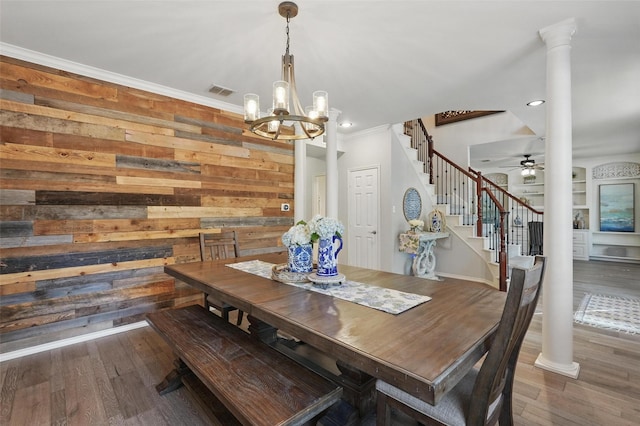 1102 Belvedere Dr, Allen, TX 75013 - dining space with ornate columns, wood finished floors, ornamental molding, stairs, and ceiling fan with notable chandelier