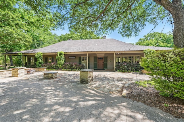 1102 Belvedere Dr, Allen, TX 75013 - single story home with a fire pit, roof with shingles, and a chimney
