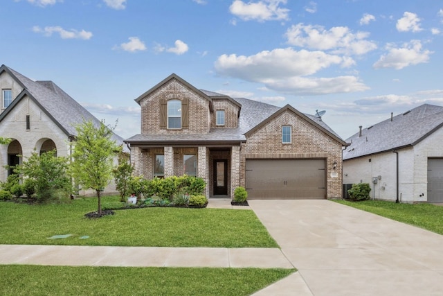 1519 Calcot Ln, Forney, TX 75126 - view of front of house featuring covered porch, driveway, a front yard, brick siding, and an attached garage