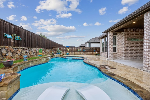 view of pool with a fenced backyard, a patio area, and a pool with connected hot tub