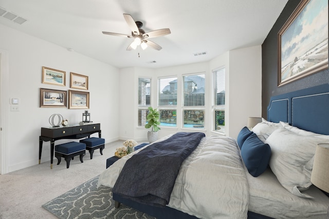 carpeted bedroom featuring visible vents, baseboards, and ceiling fan