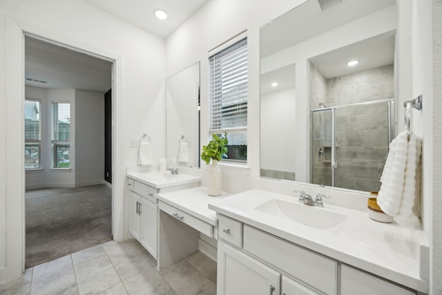 full bathroom featuring vanity, tile patterned flooring, visible vents, baseboards, and a stall shower