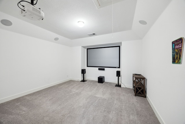 cinema featuring carpet floors, baseboards, a textured ceiling, and visible vents