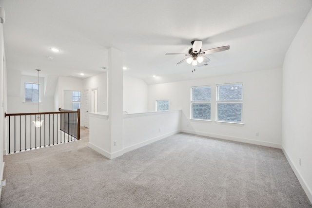 carpeted spare room featuring baseboards, a ceiling fan, and recessed lighting