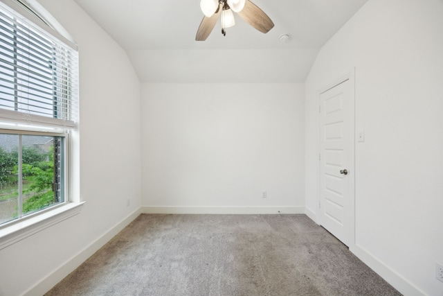 spare room featuring baseboards, a ceiling fan, carpet, and lofted ceiling