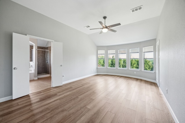 unfurnished room with vaulted ceiling, a ceiling fan, wood finished floors, baseboards, and visible vents