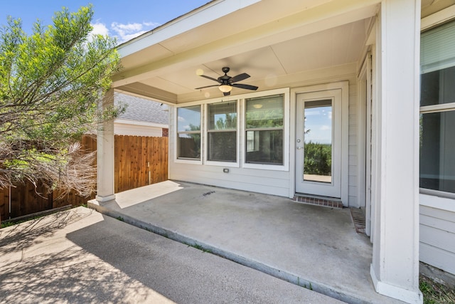 view of patio / terrace with fence and a ceiling fan