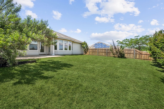 view of yard featuring a patio area and a fenced backyard