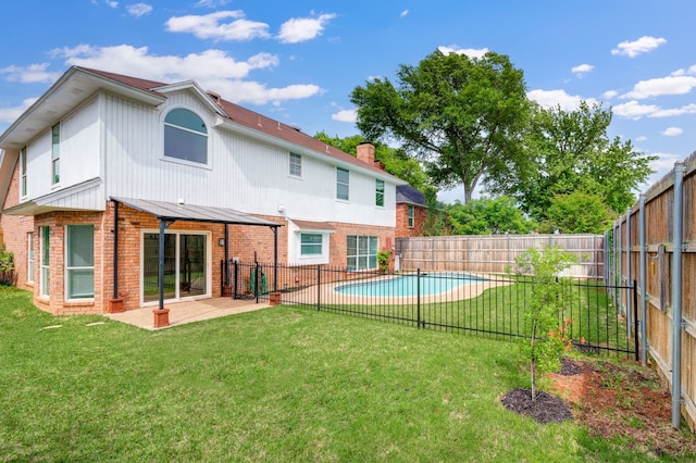 back of house with a patio, a fenced backyard, a chimney, brick siding, and a lawn