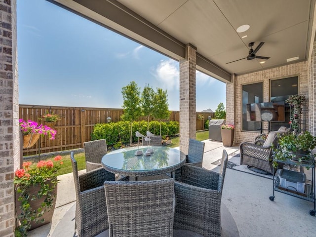 view of patio / terrace with a ceiling fan, a fenced backyard, and outdoor dining space