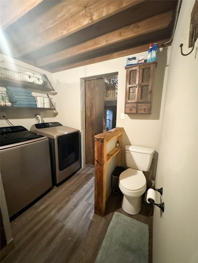 washroom with separate washer and dryer, laundry area, and wood finished floors