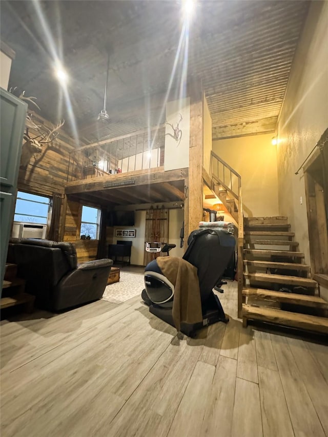 below grade area featuring stairs and wood finished floors