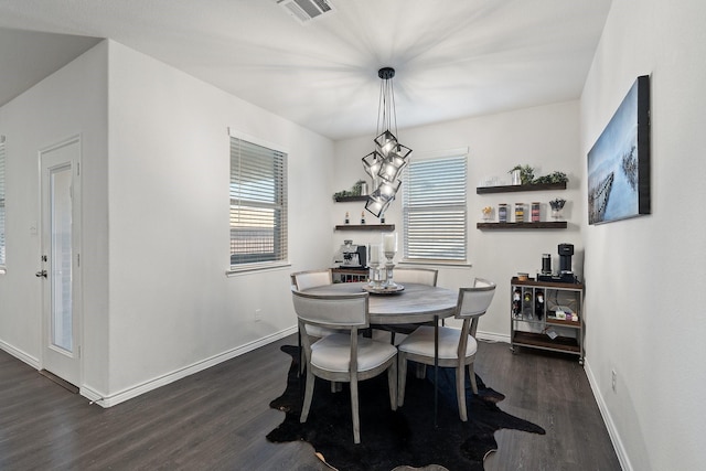 dining space featuring baseboards, visible vents, and dark wood-type flooring