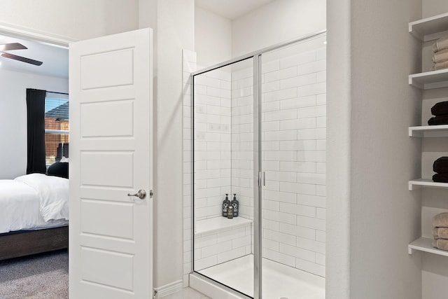 ensuite bathroom featuring connected bathroom, a shower stall, and ceiling fan