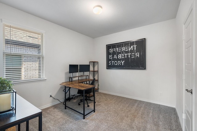 home office featuring plenty of natural light, carpet floors, and baseboards