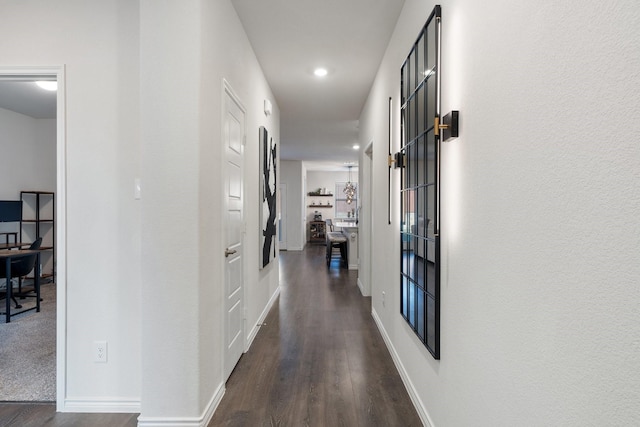 corridor with baseboards, dark wood-style floors, and recessed lighting