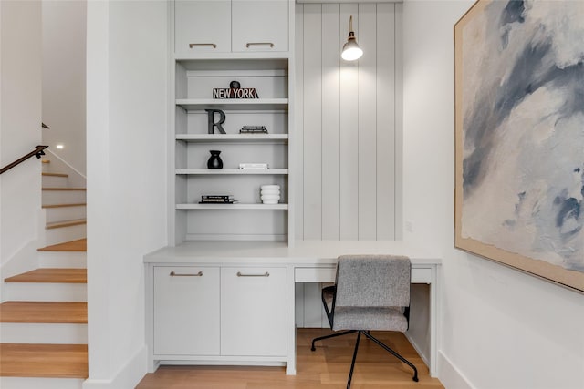 office with light wood finished floors and built in desk