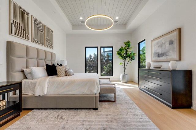 bedroom with recessed lighting, a tray ceiling, visible vents, wooden ceiling, and light wood-type flooring